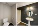 Basement bathroom features pedestal sink, dark accent wall, and glass shower at 2912 Dunhill Trl, Woodstock, GA 30189