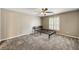 Neutral bedroom with a ceiling fan, plush carpeting and a window with plantation shutters at 2912 Dunhill Trl, Woodstock, GA 30189