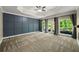 Large bedroom with accent wall, tray ceiling, and access to the backyard deck at 2912 Dunhill Trl, Woodstock, GA 30189