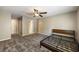 Bedroom with a ceiling fan, gray walls and plush carpeting with attached full bathroom at 2912 Dunhill Trl, Woodstock, GA 30189
