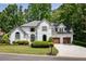 Elegant two-story home with a well-manicured lawn, two-car garage and traditional architectural details at 2912 Dunhill Trl, Woodstock, GA 30189