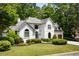 Charming two-story home with lush green lawn and manicured landscaping provides excellent curb appeal at 2912 Dunhill Trl, Woodstock, GA 30189
