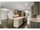 Open-concept kitchen features a large island with seating, stainless steel appliances and access to other rooms at 2912 Dunhill Trl, Woodstock, GA 30189