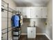 Well-organized laundry room with cabinets, a sink, and a wire rack for storage at 2912 Dunhill Trl, Woodstock, GA 30189