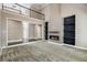 Open living room with fireplace, built-in shelves, and view of the second-story balcony at 2912 Dunhill Trl, Woodstock, GA 30189