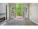 Light filled living room with a fireplace and access to a deck through multiple windows at 2912 Dunhill Trl, Woodstock, GA 30189