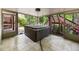 Enclosed sunroom featuring a hot tub and easy access to the outdoors with tile floors at 2912 Dunhill Trl, Woodstock, GA 30189