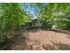 Overgrown backyard with trees offering lots of privacy and shade at 302 Cardinal Dr, Woodstock, GA 30188
