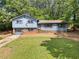 Two-story home featuring a garage, a mix of brick and siding, plus shutters at 302 Cardinal Dr, Woodstock, GA 30188