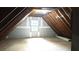 Unfinished attic space featuring a window for natural light and exposed beams, perfect for customization at 3315 Haverhill Rowe, Lawrenceville, GA 30044