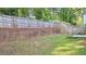 Large backyard with privacy fence, brick retaining wall, and a well-maintained lawn, offering great outdoor space at 3315 Haverhill Rowe, Lawrenceville, GA 30044