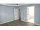 Spacious bedroom featuring light blue walls, white trim, a ceiling fan, and light grey floors at 3315 Haverhill Rowe, Lawrenceville, GA 30044