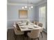 A dining room with an elegant chandelier and a modern marble-topped table at 3315 Haverhill Rowe, Lawrenceville, GA 30044