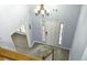 A view of the home's entryway, including a front door, adjacent sidelight windows, and an overhead chandelier at 3315 Haverhill Rowe, Lawrenceville, GA 30044