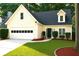 Charming single Gathering home showcasing a well-manicured lawn and an attached two-car garage at 3315 Haverhill Rowe, Lawrenceville, GA 30044