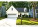 Inviting home with a neat lawn, white garage door, and a green front door at 3315 Haverhill Rowe, Lawrenceville, GA 30044