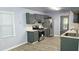 Bright kitchen featuring stylish gray cabinetry, stainless steel appliances, and tile backsplash at 3315 Haverhill Rowe, Lawrenceville, GA 30044