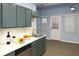 Bright kitchen featuring stylish gray cabinetry, light countertops, and door to the backyard at 3315 Haverhill Rowe, Lawrenceville, GA 30044