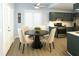 Bright eat-in kitchen features stainless steel appliances, granite countertops, and a modern ceiling fan at 3315 Haverhill Rowe, Lawrenceville, GA 30044