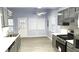 Bright kitchen featuring stylish gray cabinetry, light countertops, and stainless steel range at 3315 Haverhill Rowe, Lawrenceville, GA 30044
