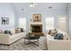 Cozy living room with a brick fireplace, vaulted ceilings, and natural light from two windows at 3315 Haverhill Rowe, Lawrenceville, GA 30044