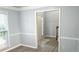 Well-lit living room space with gray walls, white trim and hardwood flooring at 3315 Haverhill Rowe, Lawrenceville, GA 30044