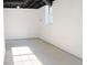 This basement features concrete floors and exposed ceiling with black pipes at 4011 Lake Carlton Rd, Loganville, GA 30052