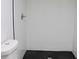 Contemporary bathroom with white subway tile shower, black hexagon tile floor and dual flush toilet at 4011 Lake Carlton Rd, Loganville, GA 30052