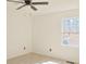 Light filled bedroom featuring a ceiling fan and a window for natural light at 4011 Lake Carlton Rd, Loganville, GA 30052