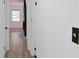 Hallway view into living room with new floors, fresh paint, and updated electrical fixtures at 4011 Lake Carlton Rd, Loganville, GA 30052