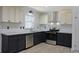 Modern kitchen features two-tone cabinets, subway tile backsplash, stainless steel appliances, and granite countertops at 4011 Lake Carlton Rd, Loganville, GA 30052