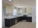 Modern kitchen features two-tone cabinets, subway tile backsplash, stainless steel appliances, and granite countertops at 4011 Lake Carlton Rd, Loganville, GA 30052