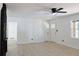 Bright living room featuring fresh white walls, a modern ceiling fan, and sleek, light-colored hardwood floors at 4011 Lake Carlton Rd, Loganville, GA 30052