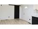 Bright living room boasts new floors, white walls, and modern accents like a sliding barn door and updated electrical fixtures at 4011 Lake Carlton Rd, Loganville, GA 30052