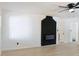 Bright living room featuring a black brick fireplace, fresh white walls, and sleek, light-colored hardwood floors at 4011 Lake Carlton Rd, Loganville, GA 30052