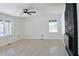 Bright living room featuring a black brick fireplace, fresh white walls, and sleek, light-colored hardwood floors at 4011 Lake Carlton Rd, Loganville, GA 30052