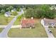 Aerial view of a two-story home with brick facade, green lawn, and tree lined backyard in a suburban neighborhood at 6932 Dalehollow Dr, Lithonia, GA 30058