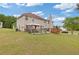 Expansive backyard featuring a large lawn, a deck, and an outdoor gazebo, perfect for entertaining at 6932 Dalehollow Dr, Lithonia, GA 30058