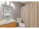 This bathroom features a vanity, a standard toilet and a shower/tub combination with a patterned curtain at 6932 Dalehollow Dr, Lithonia, GA 30058