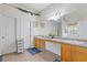 A bright bathroom featuring double sinks, a tub, neutral walls, and two doors at 6932 Dalehollow Dr, Lithonia, GA 30058