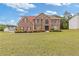Beautiful brick two-story home with a well-manicured lawn and a vibrant garden at 6932 Dalehollow Dr, Lithonia, GA 30058