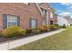 Charming brick home featuring a neatly landscaped front yard and walkway at 6932 Dalehollow Dr, Lithonia, GA 30058