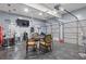 Finished garage featuring bar, TV, and game table, offering a versatile and stylish entertainment space at 6932 Dalehollow Dr, Lithonia, GA 30058
