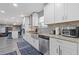 Modern kitchen with white cabinets, stainless steel appliances, and stylish backsplash at 6932 Dalehollow Dr, Lithonia, GA 30058