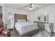This main bedroom features a tufted headboard, ceiling fan, and mirrored furniture at 6932 Dalehollow Dr, Lithonia, GA 30058