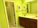 Bright bathroom featuring double sinks, framed mirror and a doorway view of the bathtub and shower at 7550 Star Magnolia, Lithonia, GA 30058