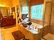 Bright bathroom features a soaking tub with decorative window and a separate glass shower, plus attractive tile floors and walls at 7550 Star Magnolia, Lithonia, GA 30058