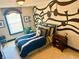 Stylish bedroom with decorative wall art, unique light fixture and comfortable bed at 7550 Star Magnolia, Lithonia, GA 30058