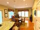 Charming dining area features hardwood floors, large windows, and an adjacent kitchen area, creating a cozy and functional space at 7550 Star Magnolia, Lithonia, GA 30058