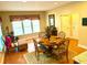 Charming dining area features hardwood floors, large windows, and an adjacent kitchen area, creating a cozy and functional space at 7550 Star Magnolia, Lithonia, GA 30058